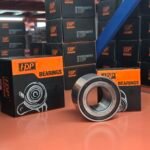 Steel wheel hub bearing units and plain cartons on a pallet in an automotive parts warehouse