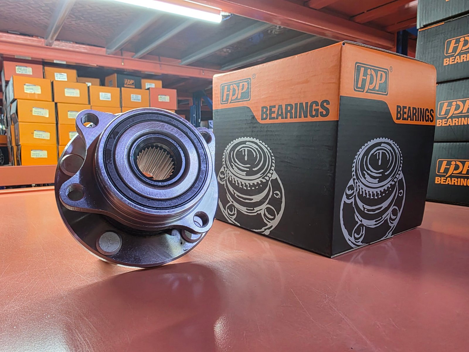 How to Vet a WhatsApp Wheel Hub Distributor | HJDP Guide 6 Gloved hands comparing a used and a new wheel hub bearing with a caliper on a workshop bench
